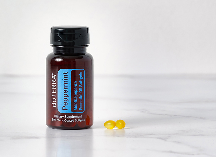 Bottle of Peppermint Oil Softgels on a granite countertop.
