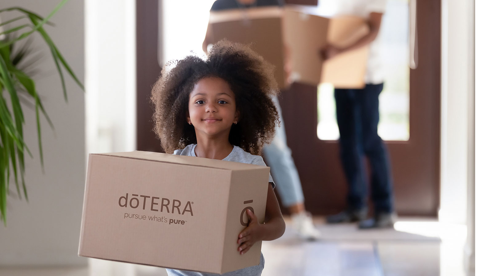 A child holding a doTERRA shipping box