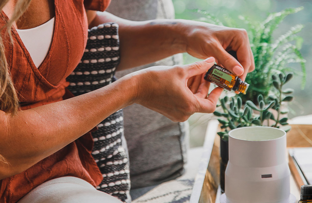 A woman diffusing basil essential oil
