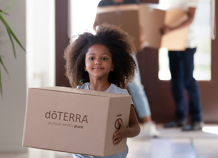 A child holding a doTERRA shipping box
