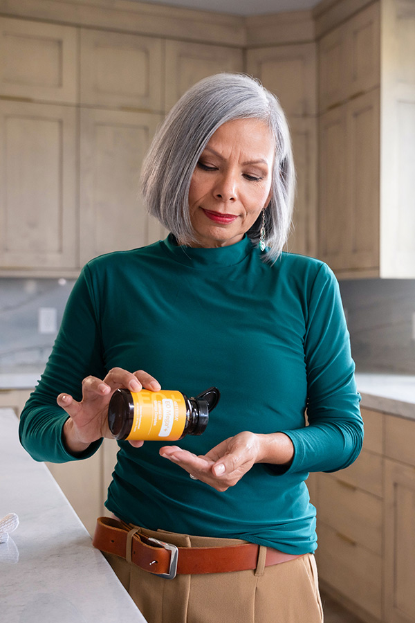 Lady taking doTERRA Supplements