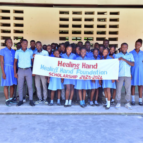 Group of students holding a banner saying Healing Hand Foundation Scholarship 2023-2024.