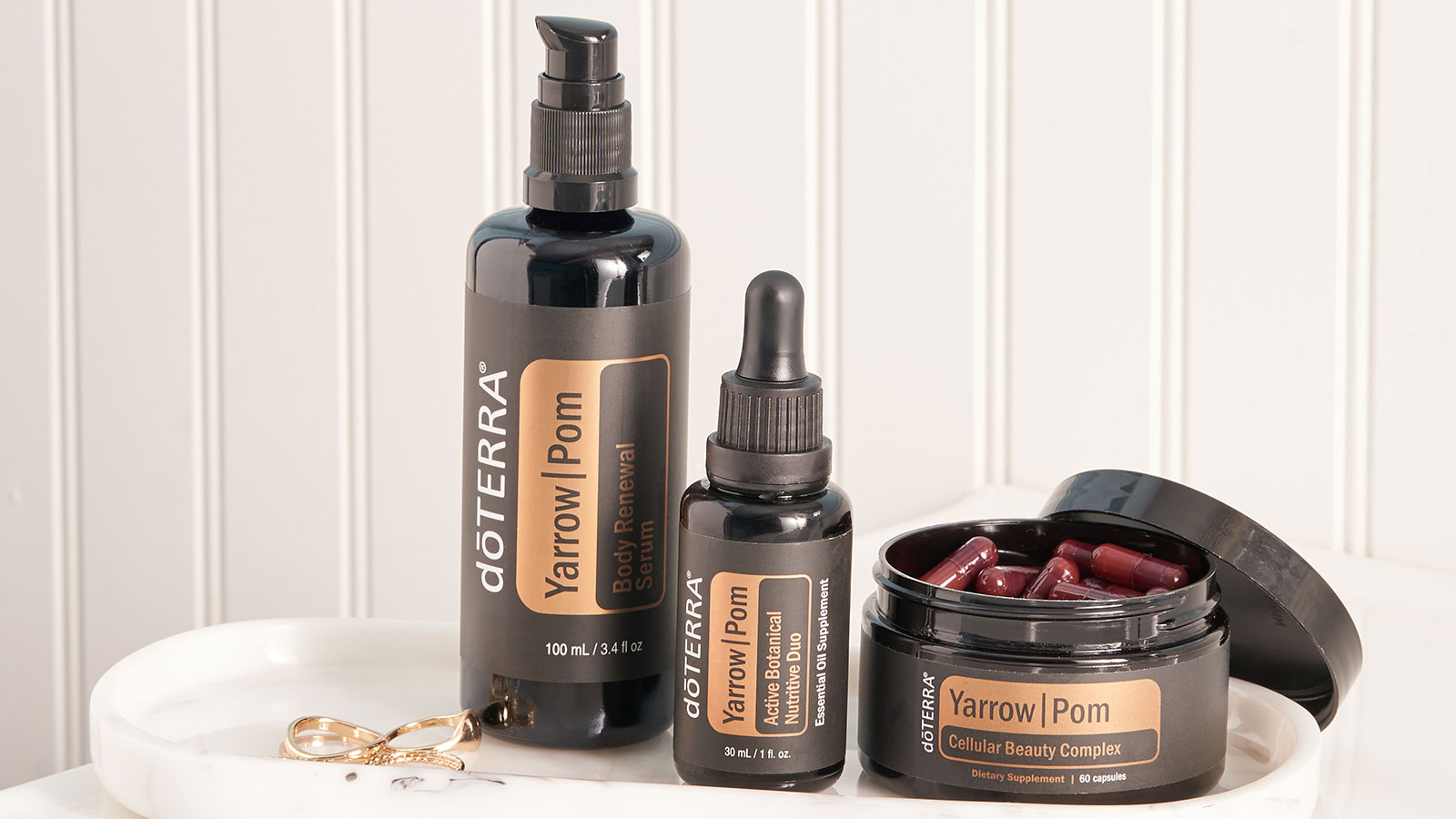 White, oval tray seated on a white counter. doTERRA’s Yarrow|Pom Collection sitting on top of the tray.  