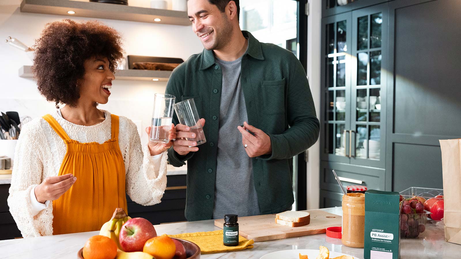 Two people talking and holding PB Restore