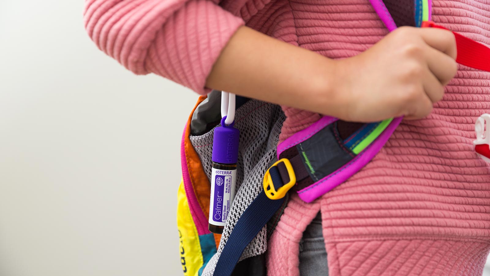 A child carrying her backpack with doTERRA Calmer