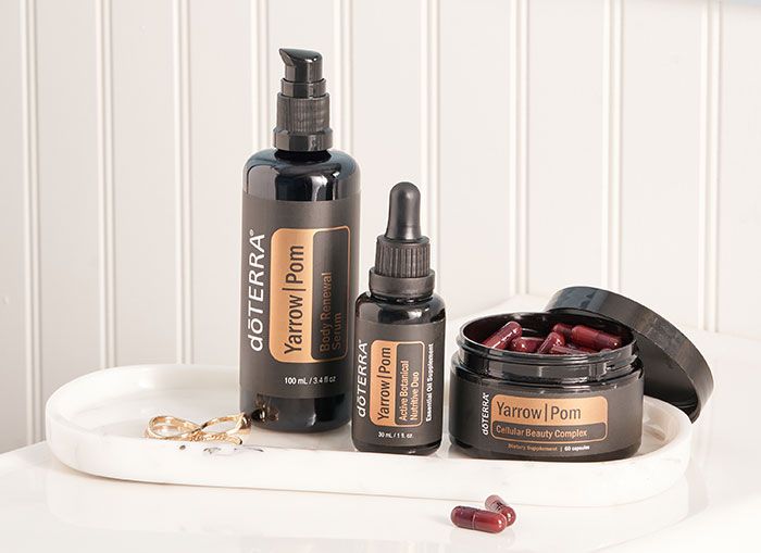 White, oval tray seated on a white counter. doTERRA’s Yarrow|Pom Collection sitting on top of the tray.  