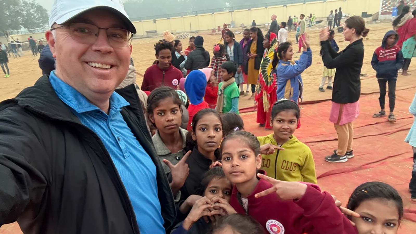 Dr. Russell Osgothorpe posing for a selfie with several children from the leprosy-affected community.