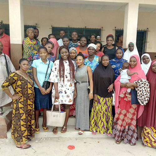 A group of people posing for a photo in front of a building.