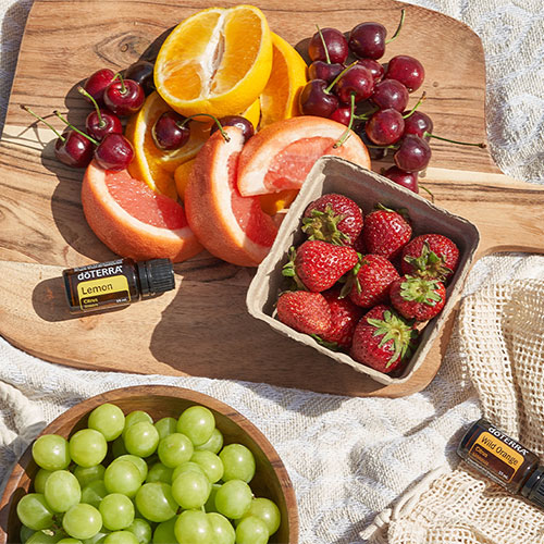 Wood cutting board with fruits and Essential Oils on the side