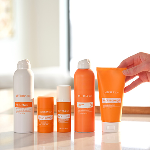 doTERRA sun Products with a hand touching doTERRA sun face and body