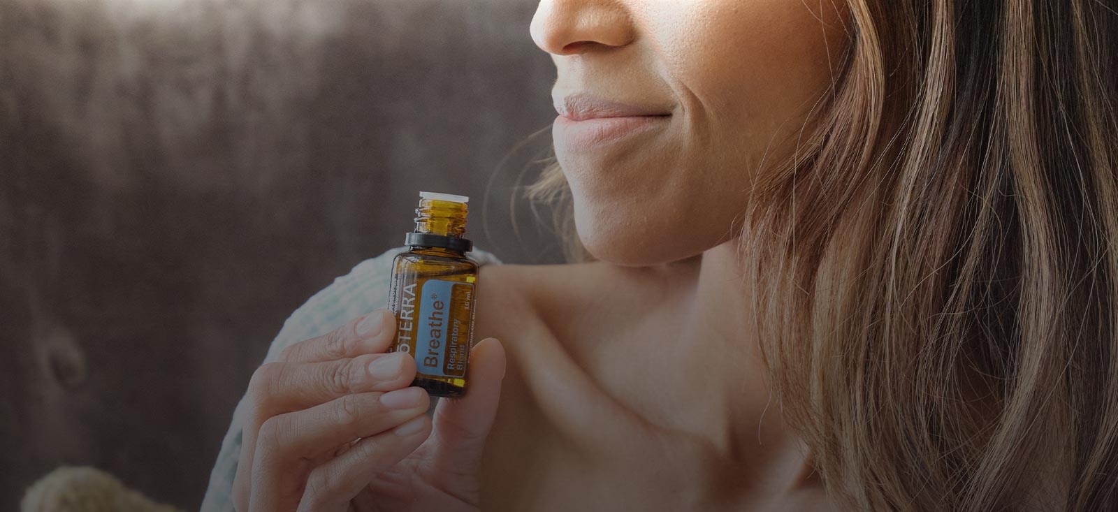 Woman holding Breathe Essential Oil